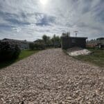 New gravel driveway and rock landscaping installation for a residential property in Spearfish, South Dakota completed by South Dakota Services.