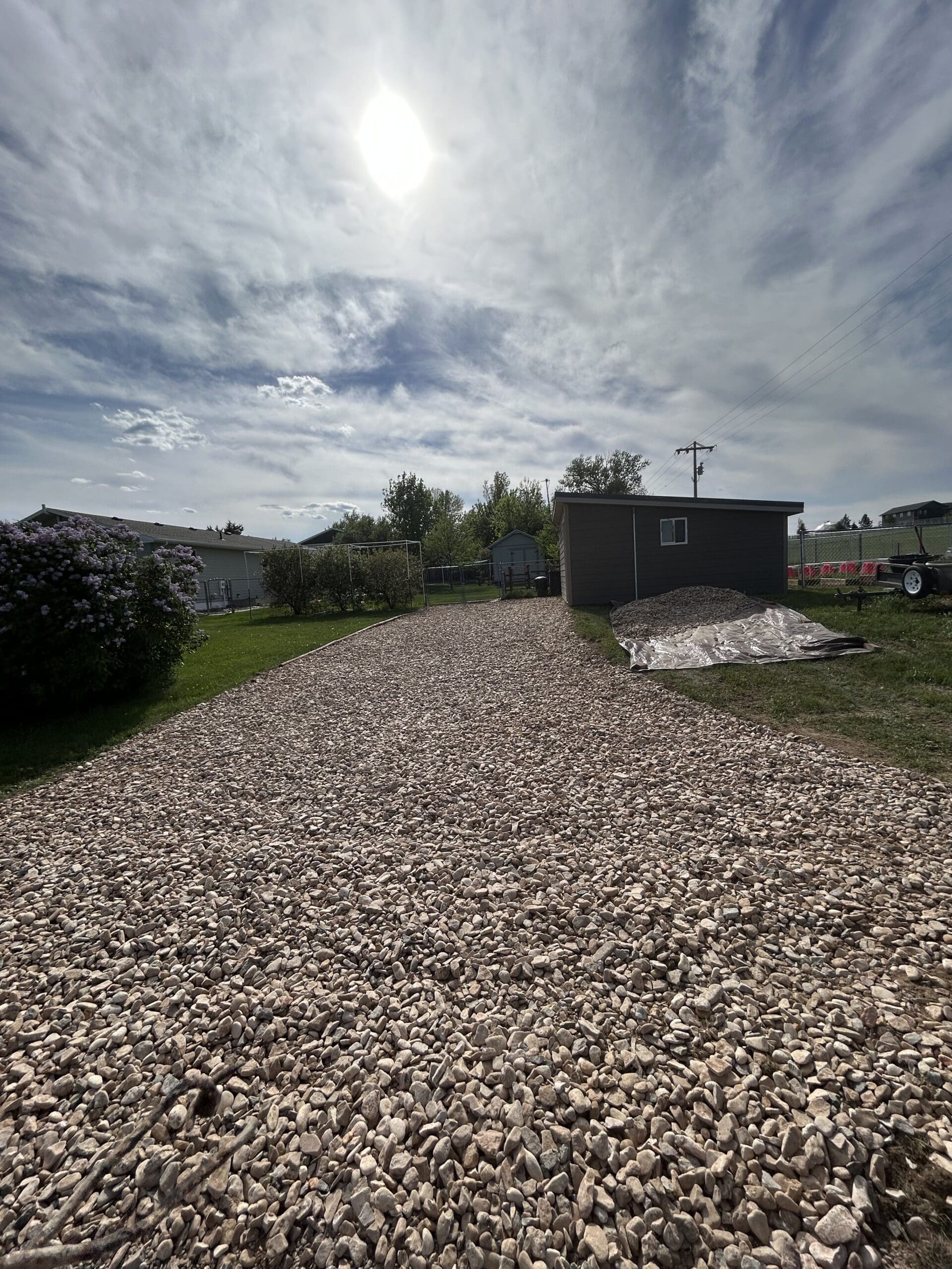 New gravel driveway and rock landscaping installation for a residential property in Spearfish, South Dakota completed by South Dakota Services.