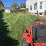 South Dakota Services lawn mower on a freshly striped residential lawn in Spearfish, SD after professional mowing and yard maintenance.
